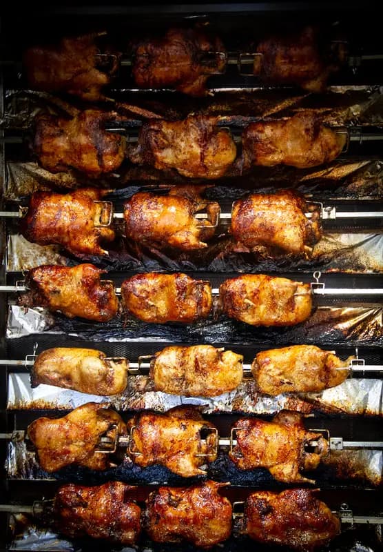 Golden roasted ducks on the spit